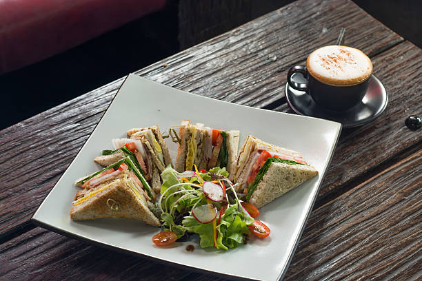 istock Sandwich and salad with cappuccino coffee as background 577638918