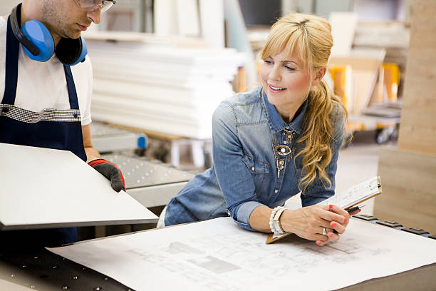 istock Designer with worker at furniture workshop 577639388