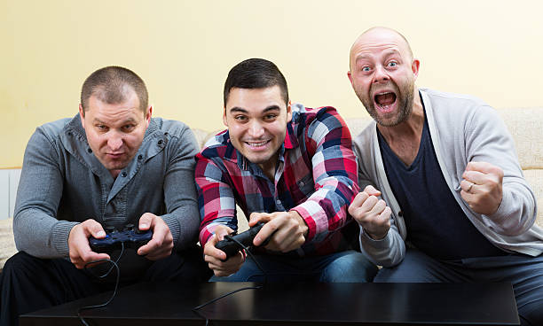 istock Adult guys sitting with joysticks 577639398