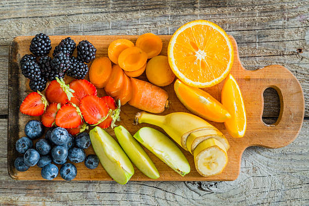 istock Fruits and berries on wood board 577643952