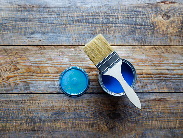 istock jar with blue paint on the wooden background top view 577644296