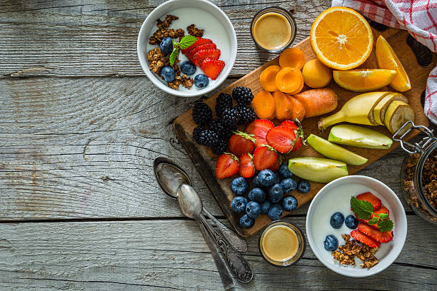 istock Breakfast - yogurt with fruits granola and coffee 577644306