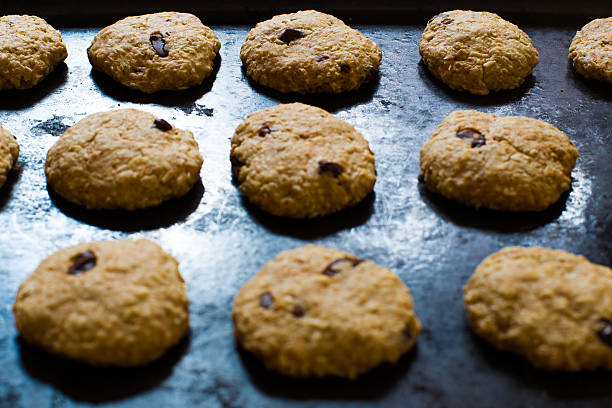 istock Oatmeal cookies with chocolate on baking sheet 577645378