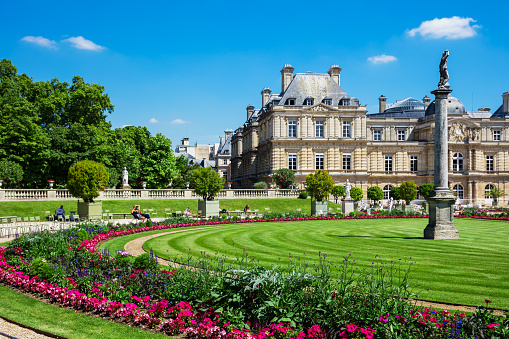 Paris, France - Jule 07, 2016: People enjoy sunny day in the Luxembourg Garden in Paris. Luxembourg Palace is the official residence of the French Senate.