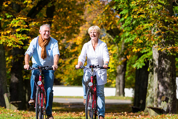 istock Seniors on bicycles having tour in park 577647416
