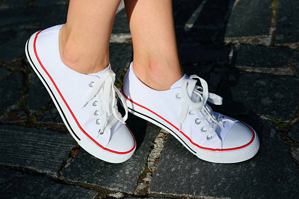 istock White gumshoes on legs. Hipster style 577647866