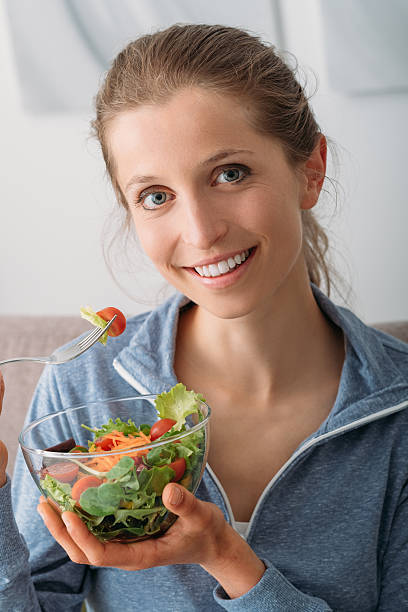 istock Smiling woman having a salad 577649052