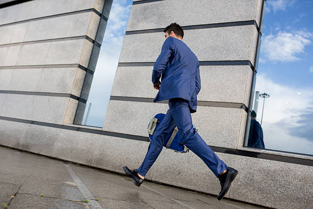 istock Businessman running on the street with suitcase. 577649202