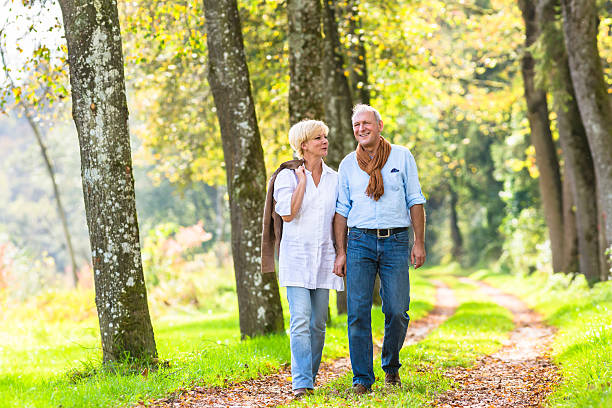 istock Senior couple having leisure walk in woods 577649822