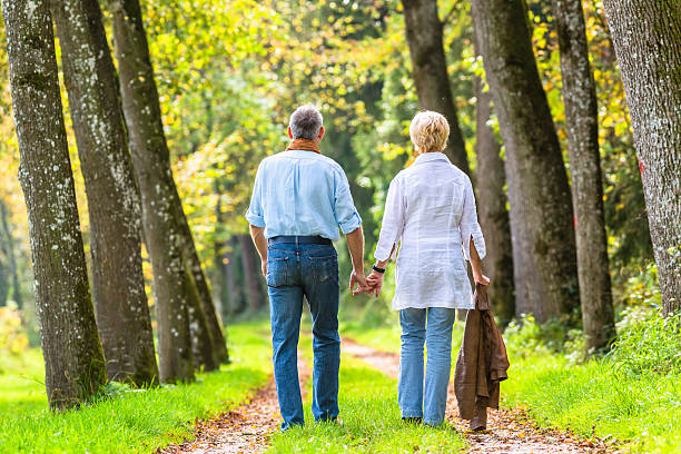 istock Senior couple having leisure walk in woods 577649906