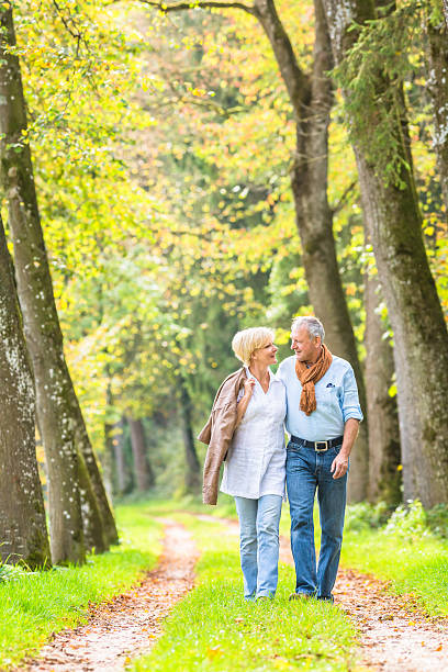 istock Senior couple having leisure walk in woods 577650448
