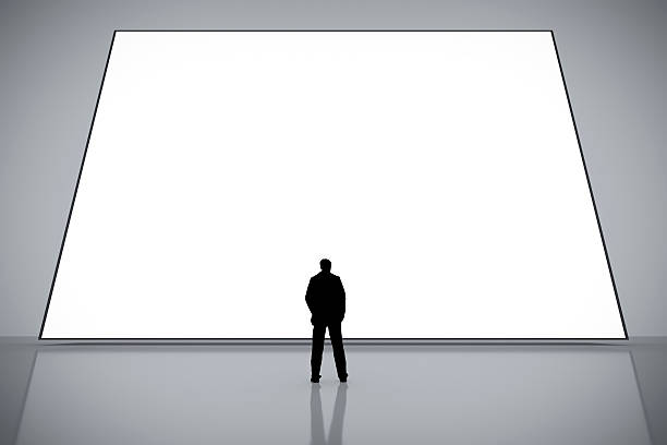 istock man in front of a big white screen 577650480