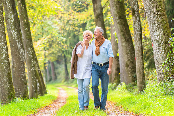 istock Senior couple having leisure walk in woods 577650550