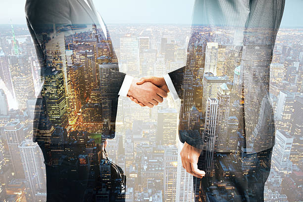 istock Businessmen shaking hands city background 577651304