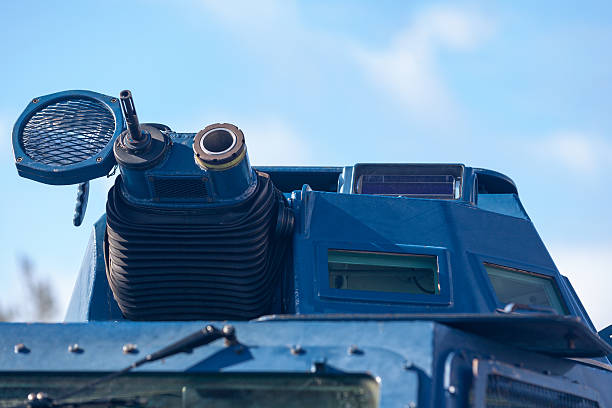 Close up on the machine gun and grenade launcher of an armored vehicle from the 