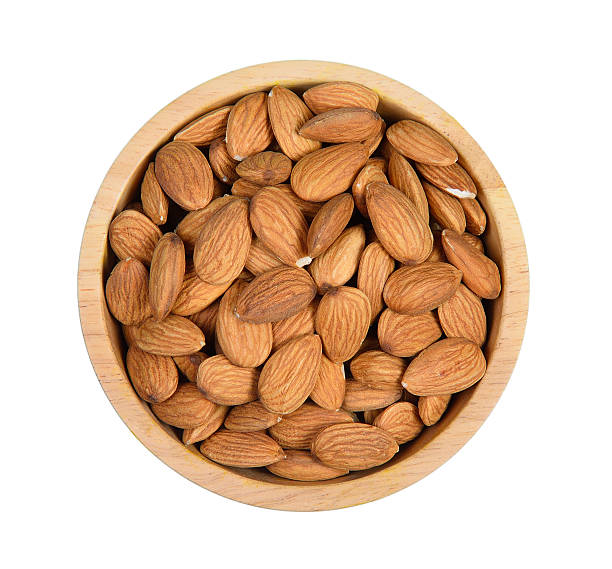 istock Top view dried almond in wood bowl on white background. 577655290