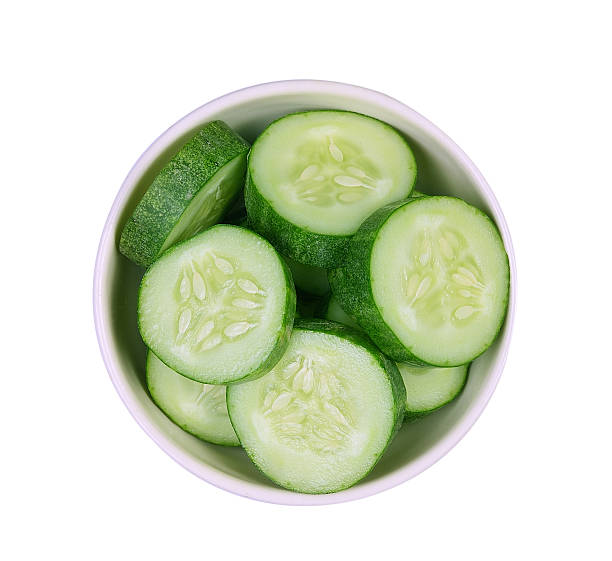 istock Fresh slice cucumber in white bowl on white background 577656704