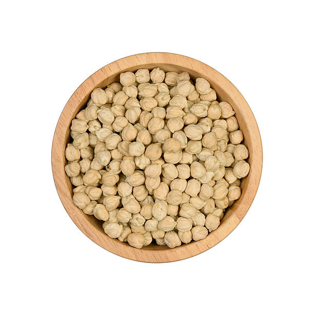 istock Top view garbanzo beans in wooden bowl on white background 577659904