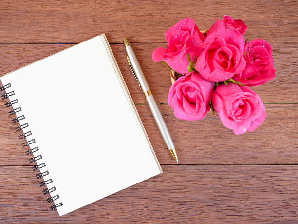 istock Bouquet pink rose flower and blank notebook 1 577660124