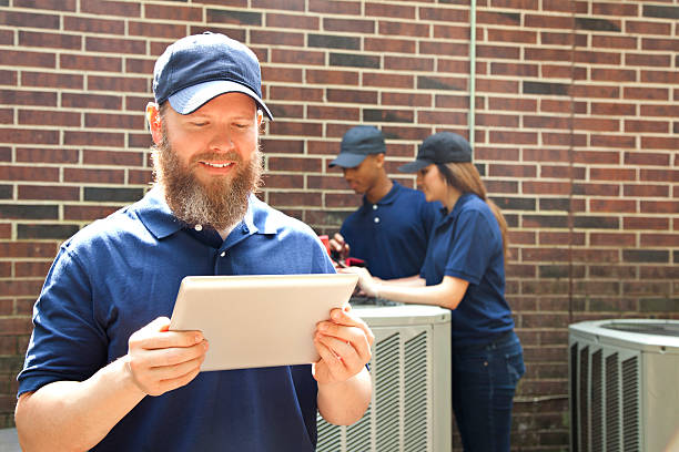 istock Air conditioner repairmen work on home unit. Blue collar workers. 577660202