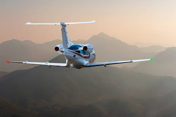 istock Airplane flying above Alps or other mountain at sunset. Travel 577932068