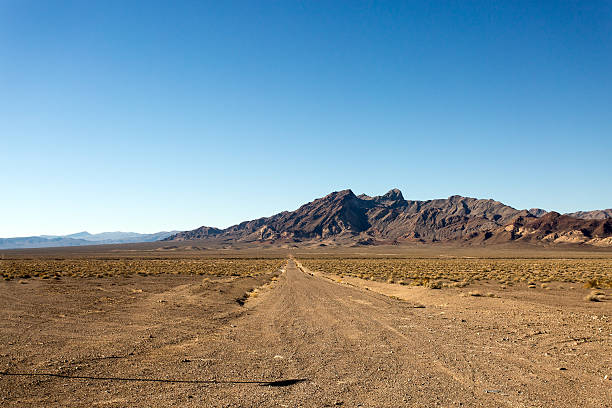 istock Straight Desert Dirt Road in California 577932096