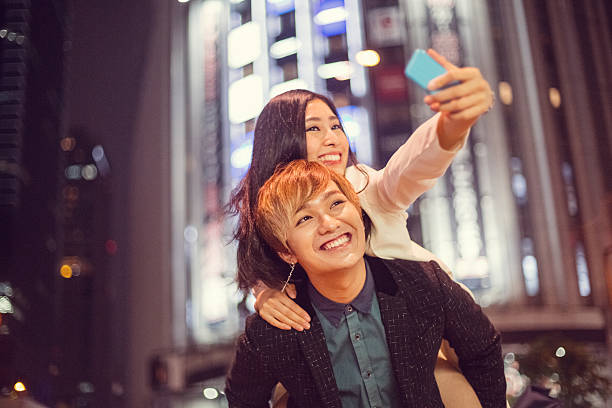 istock Man piggybacks girl for a selfie 577933110