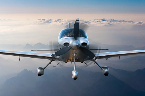 Privat plane or aircraft flight surrounded by mountains and rocks.