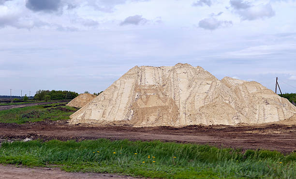 istock Yellow excavator working digging in sand quarry 577934184