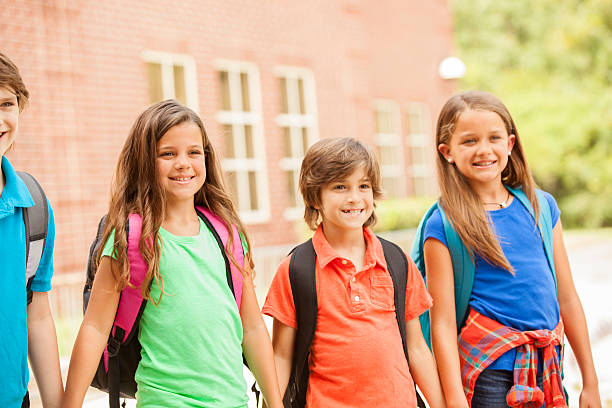 istock Back to School:  Elementary-age children, friends on school campus. 577934542