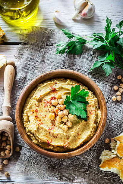 istock Hummus in wooden bowl  on the table. 577935736