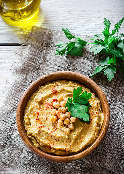 istock Hummus in wooden bowl  on the table. 577935858
