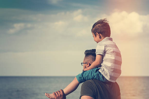 istock Dad and son enjoying the sea views 577936924