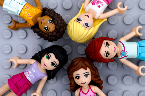 Tambov, Russian Federation - July 06, 2016: Five Lego Friends girl minifdolls - Andrea, Mia, Olivia, Stephanie, Emma - on Lego gray baseplate background. Studio shot.