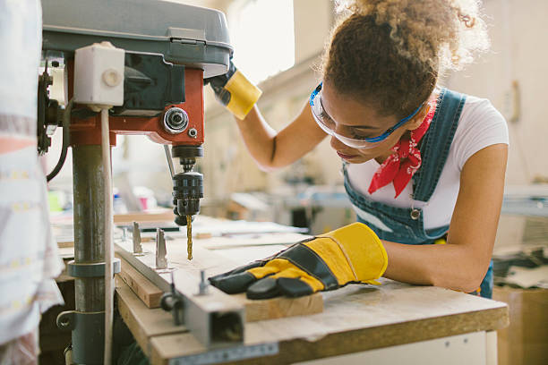 istock Latina Carpenter Drilling Plank In Her Workshop 577940722