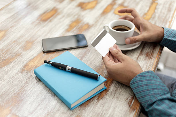 istock Man Drinking Coffee and Making Mobile Payment With Smartphone 577941126