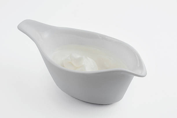istock Gravy boat with sour cream on a white background 577941338