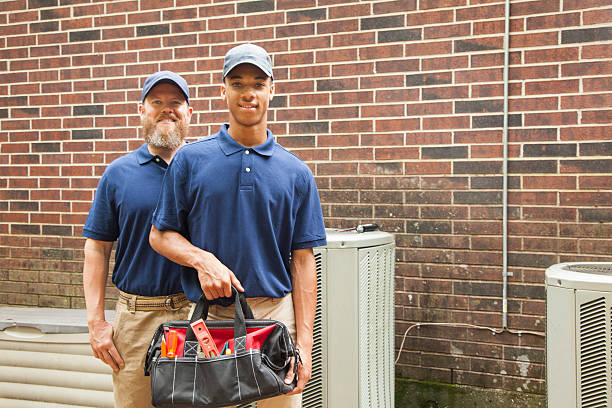istock Air conditioner repairmen work on home unit.  Tool bag. 577941508