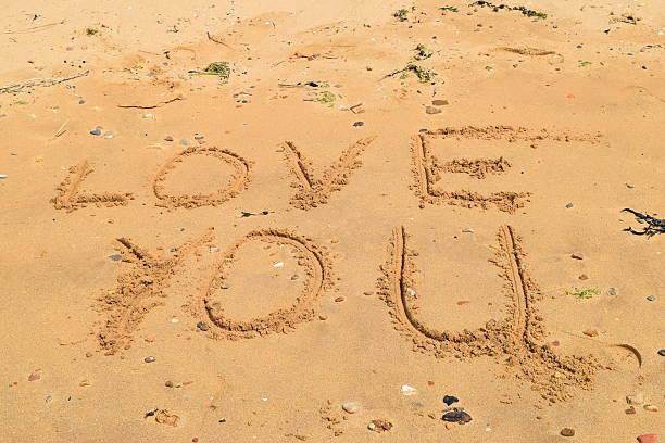 istock love you written in the sand beach textography background 577946068