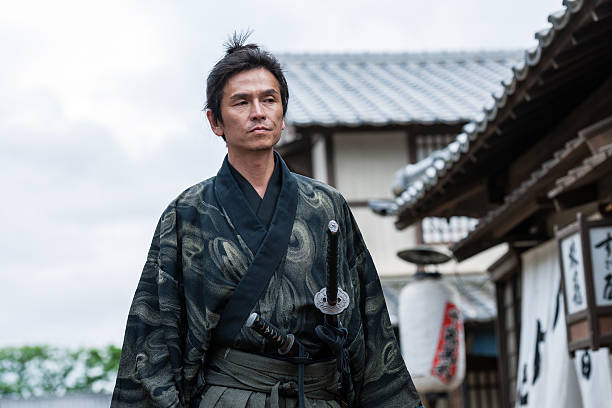 istock , Samurai walk in the middle of a village street 577946584