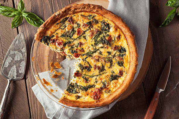 Homemade Cheesy Egg Quiche for Brunch Homemade Cheesy Egg Quiche for Brunch with Spinach and Tomato quiche stock pictures, royalty-free photos & images