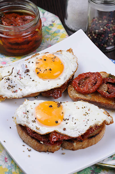 Sandwich with dried tomatoes and egg Sandwich with slices of dried tomatoes and egg flavored spices sandwich new hampshire stock pictures, royalty-free photos & images