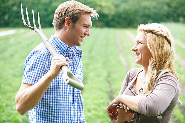 istock Couple Working In Field On Organic Farm 577948230