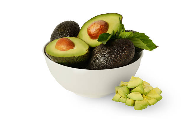 istock Whole Half Diced Hass Avocados Basil Leafs White Bowl Background 577949728