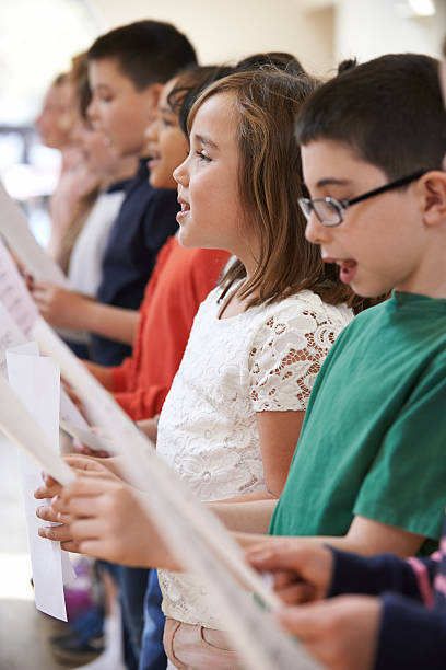 istock Group Of School Children Singing In Choir Together 577950424