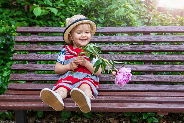 istock Adorable toddler playing with a flower 577950792