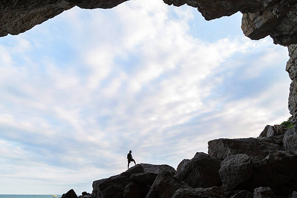 istock Man in the cave with a sky background. 577951652