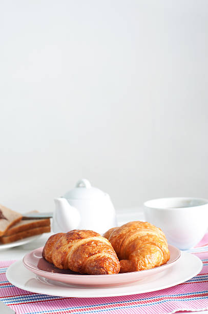 istock Sunday breakfast. Croissants with tea and peanut butter. 577951784