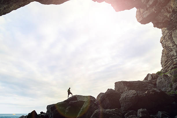 istock Man in the cave with a sky background. 577951808