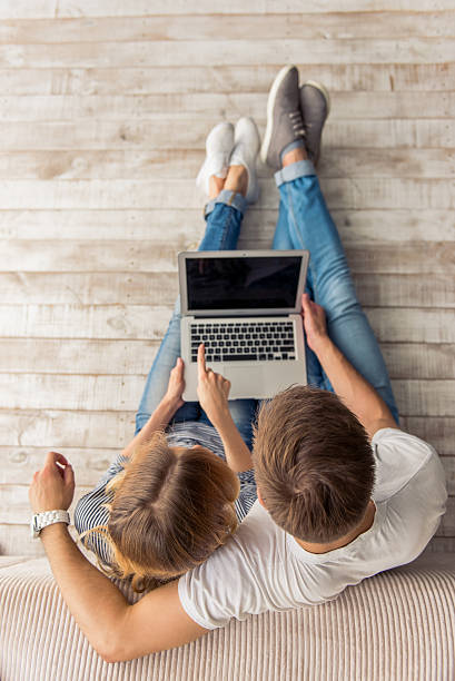 istock Beautiful young couple with gadget 577953260